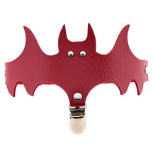 Red bat-shaped garter with pointed ears and wide wings above a silver-tone stocking clip.