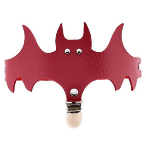 Red bat-shaped garter with pointed ears and wide wings above a silver-tone stocking clip.