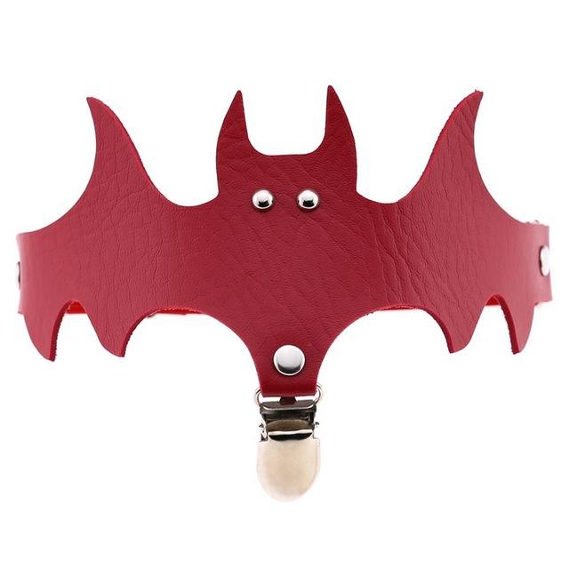 Red bat-shaped garter with pointed ears and wide wings above a silver-tone stocking clip.