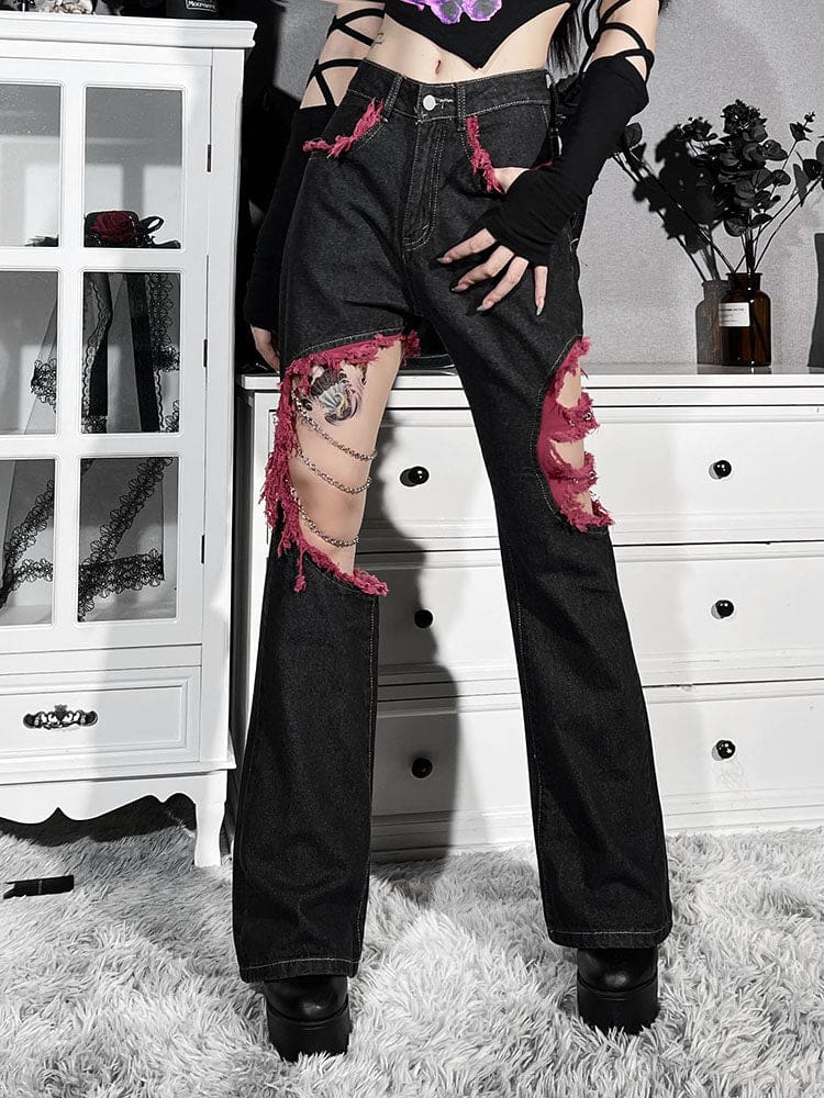 Front view of the chain-detail jeans with a hand resting at the thigh, showing the red-trimmed pocket and open knee panels.