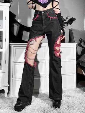 Angled worn view of the distressed flare jeans, with the high waistband above chain-draped and fabric-barred leg cutouts.