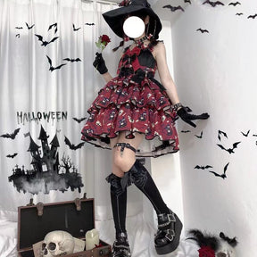 Red tiered Halloween bow dress worn indoors with a black pointed hat and dark footwear, showing the full printed skirt against bat decorations.