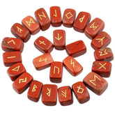 Red jasper rune stones arranged in a circle, with brick red with darker markings polished surfaces and gold-coloured characters. The set includes a blank stone.
