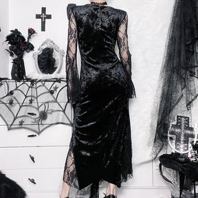 Rear view of the black velvet dress worn indoors, showing the fitted covered back and sheer lace sleeves.