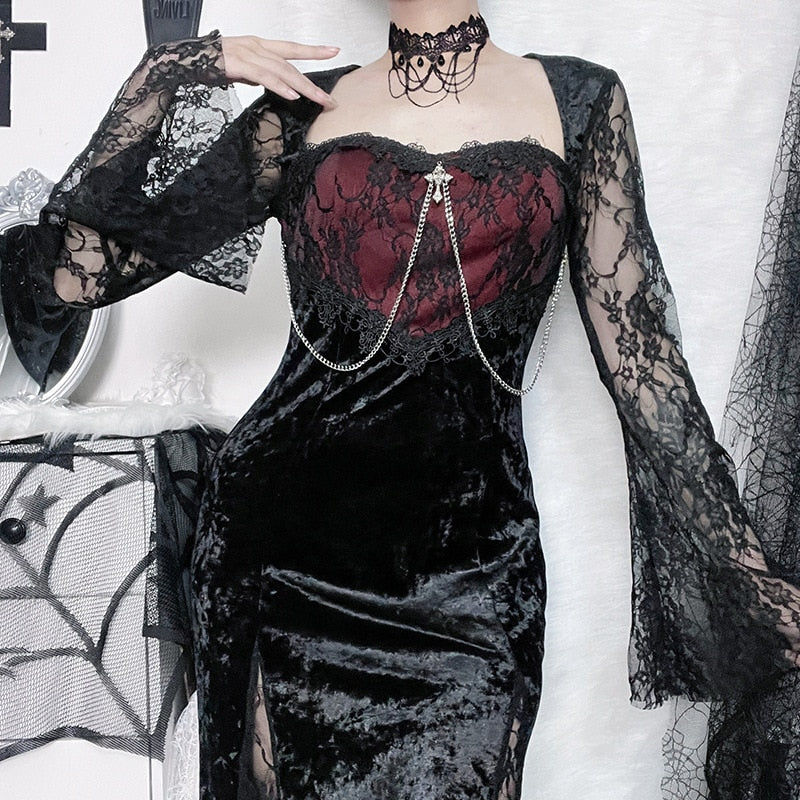 Upper-body view showing the red lace-covered panel, silver-tone cross and chains against the black velvet dress.