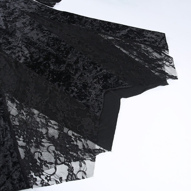 Close view of the dress's shaped lower edge, where black velvet panels meet scalloped floral lace.