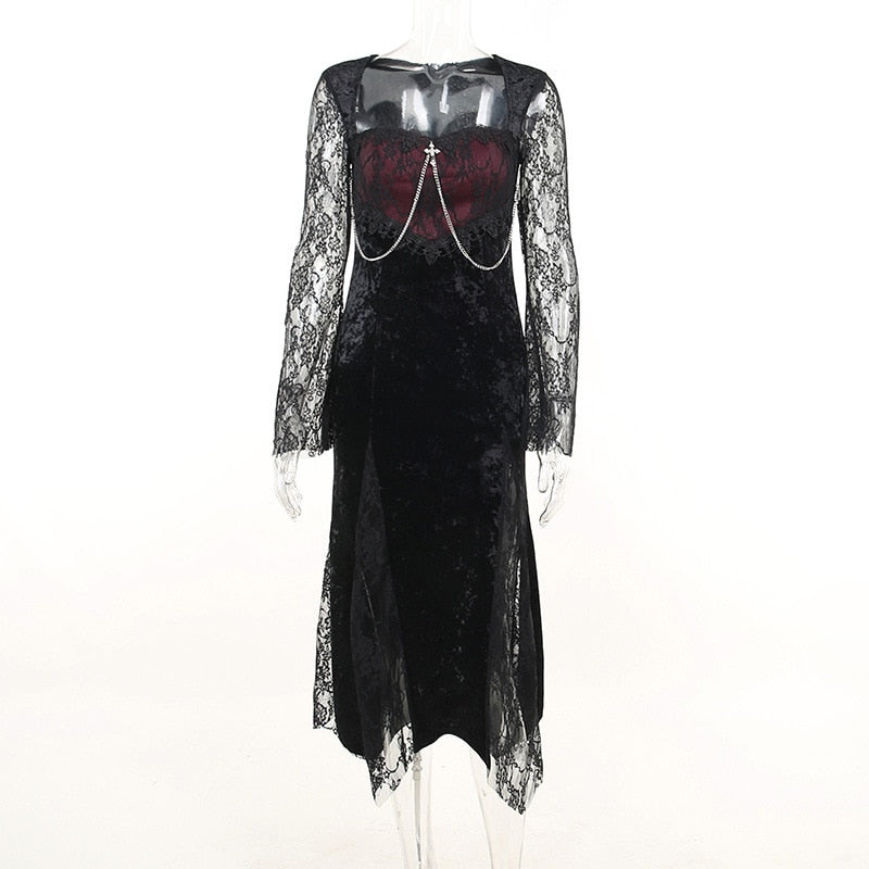 Front mannequin view of the black velvet dress with a wine-red lace-covered bodice, draped chains and bell sleeves.