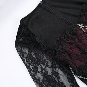 Close view of the dress laid flat with floral lace around the bodice and the back zip visible behind the neckline.