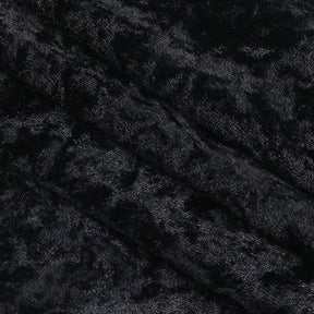 Close-up of the dress's crushed black velvet, showing mottled highlights across the pile.