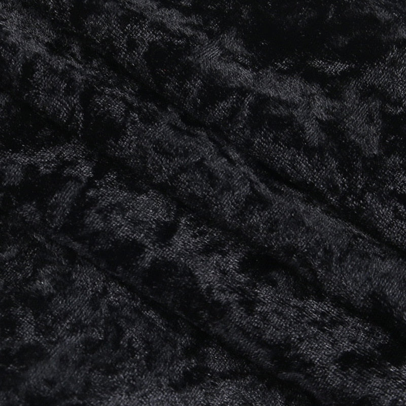 Close-up of the dress's crushed black velvet, showing mottled highlights across the pile.
