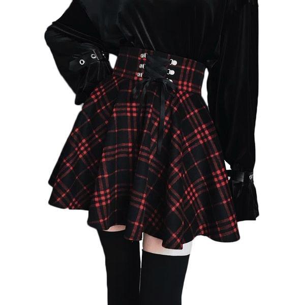 Red plaid corset-waist skirt shown in a cropped outfit view, with one hand resting at the waist.