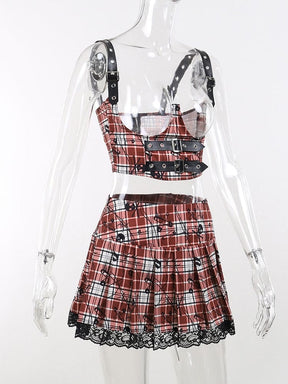 Angled mannequin view of the red plaid underbust crop top and skirt set. Buckled shoulder straps and the flared pleated skirt shape are visible.