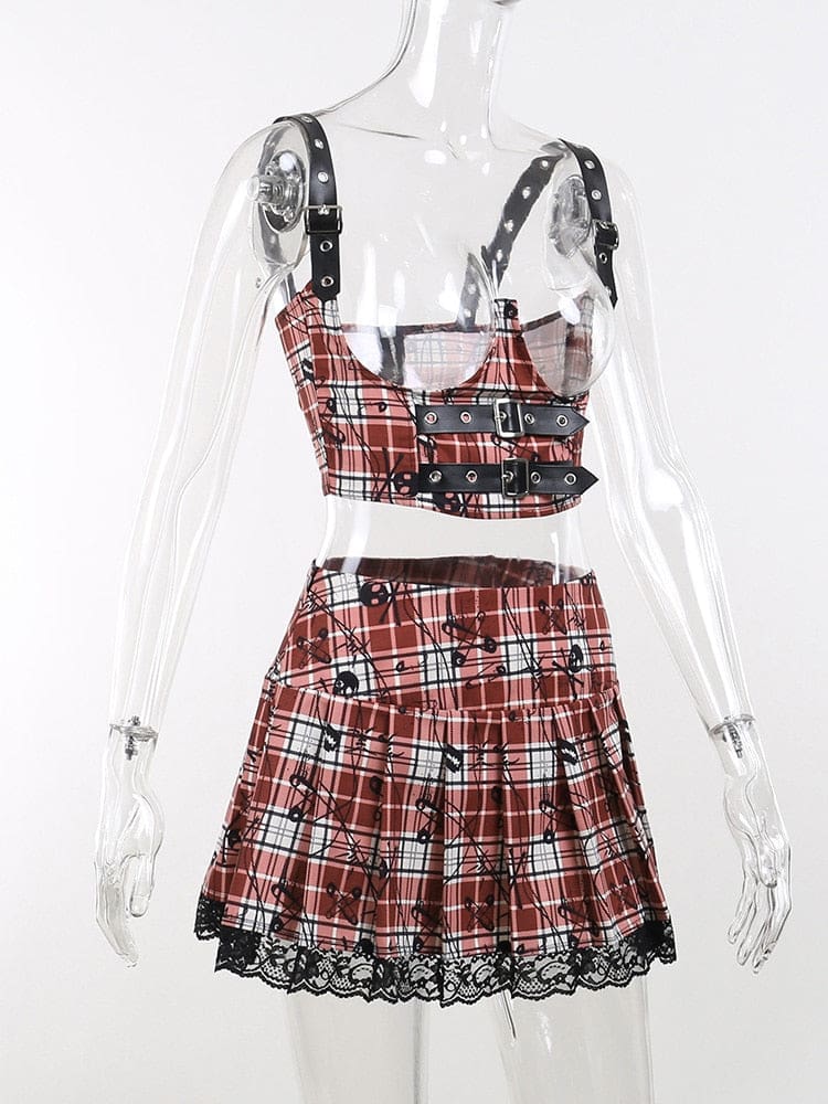 Angled mannequin view of the red plaid underbust crop top and skirt set. Buckled shoulder straps and the flared pleated skirt shape are visible.