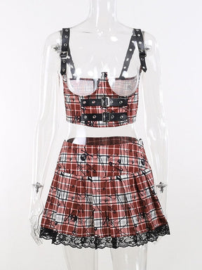 Front view of the red plaid two-piece set on a clear mannequin, showing the open-bust top, three buckle bands and pleated lace-trim skirt.