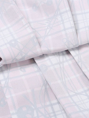 Close-up of the reverse side of the plaid fabric, showing the paler print and folded seam on the two-piece set.