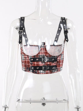 Red plaid underbust crop top on a clear mannequin, showing its deep open-bust cutouts, shoulder straps and three black front buckle bands.