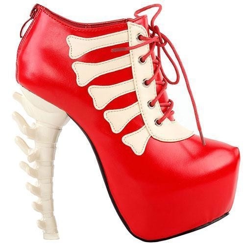 Red platform ankle boot displayed alone, with matching laces, pale bone-shaped trim and a pale sculpted spine heel.