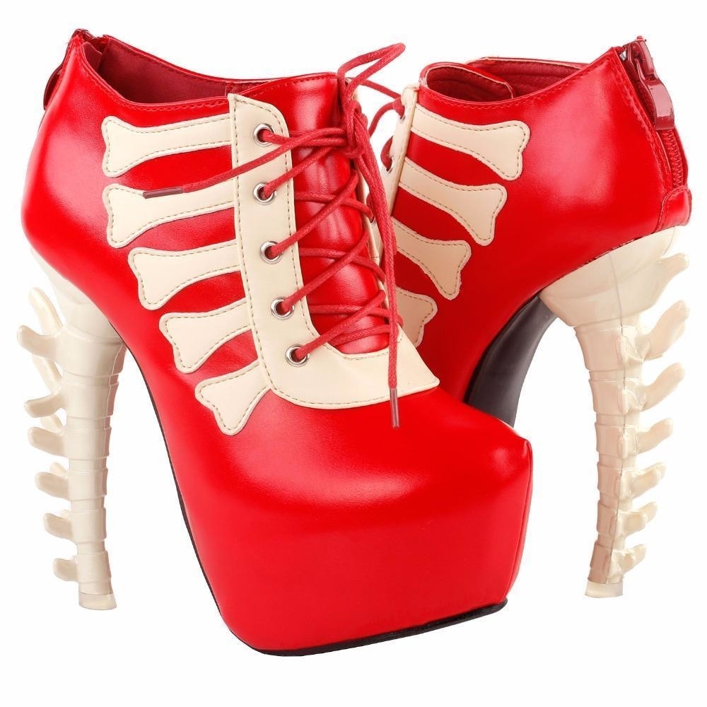 Pair of red skeleton platform ankle boots displayed together, with red laces over pale bone-shaped front trim.