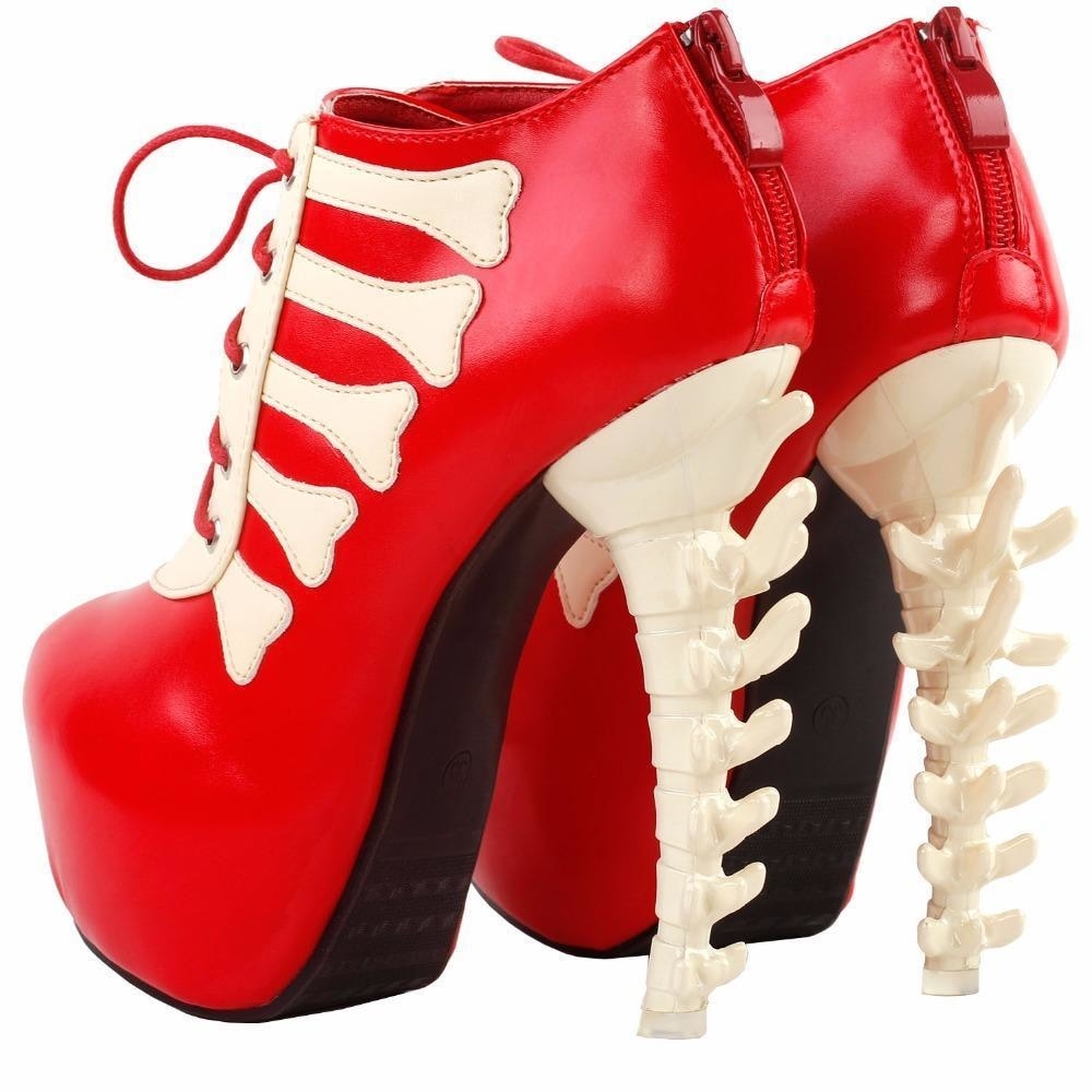 Red skeleton boots displayed from the back with one sole tilted forward, revealing the rear zippers and sculpted heels.