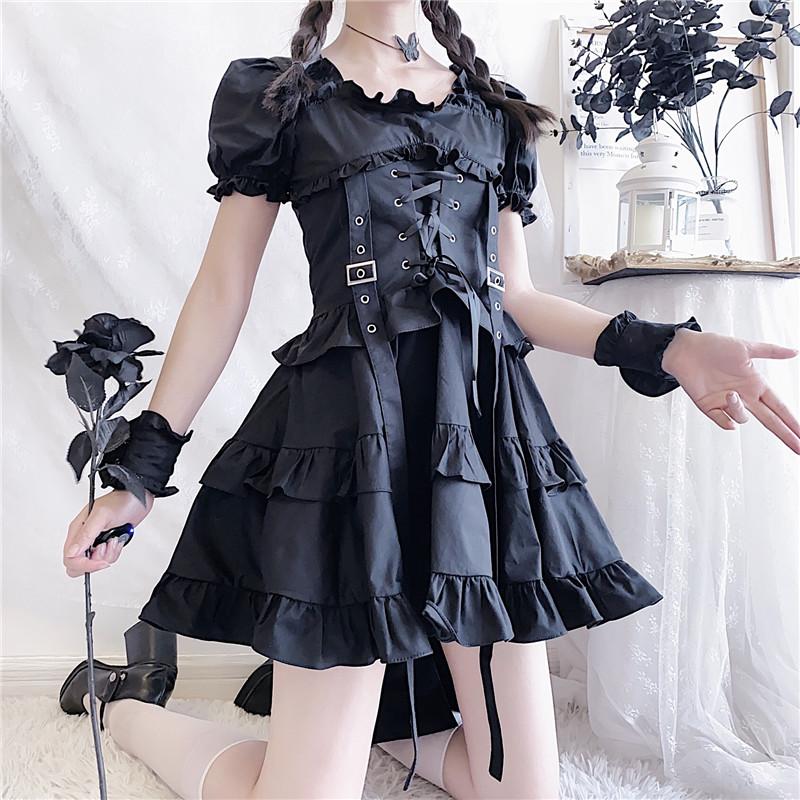 Repeated standing view of the black Renaissance-inspired dress, with a layered ruffle hem and a black rose in one hand.