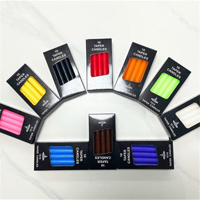 Ritual candle boxes arranged in a curved display, with the different candle colours visible together.