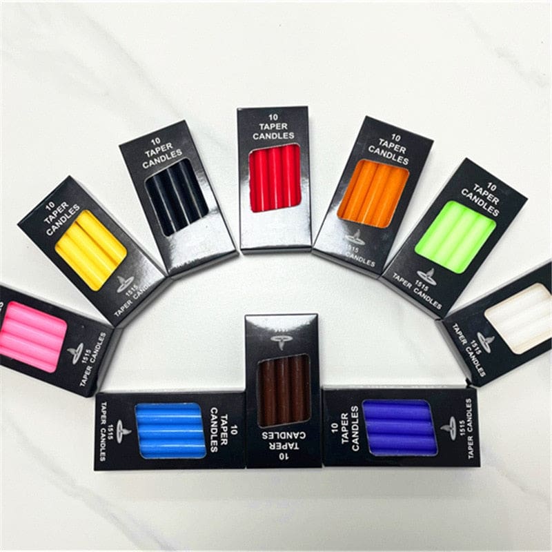 Ritual candle boxes arranged in a curved display, with the different candle colours visible together.