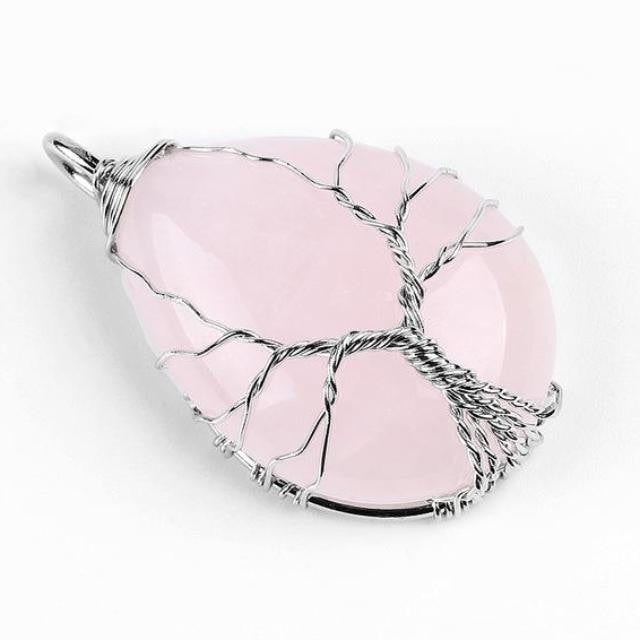 Pale pink rose quartz pendant with a silver-tone Tree of Life wire design across the stone.