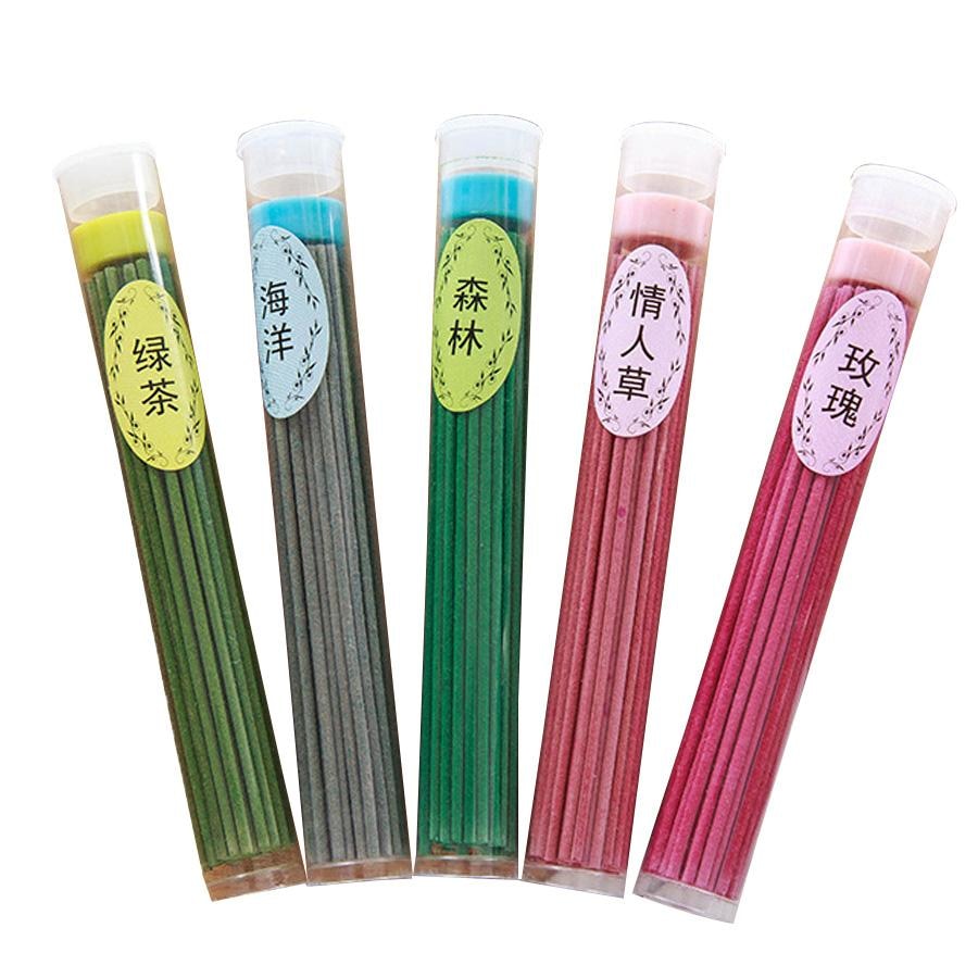 Five clear tubes of coloured incense sticks arranged together, showing green tea, ocean, forest, Desmodium gyrans and rose labels. Each fragrance is a separate option.