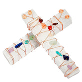 Two white selenite wands crossed on white, each wrapped with copper wire and a line of colourful irregular crystal accents.