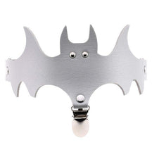 Silver-coloured bat garter with a matching leg band and a clip below the winged centre.
