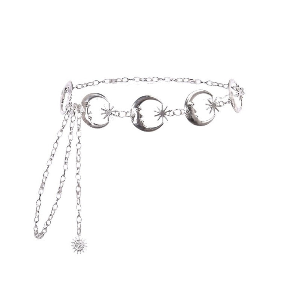 Silver-tone chain belt isolated on white, showing crescent moon links, star details, an adjustable chain and dangling celestial charm.