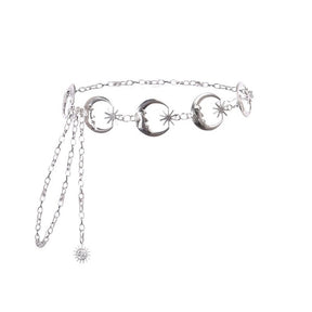 Silver-tone chain belt isolated on white, showing crescent moon links, star details, an adjustable chain and dangling celestial charm.