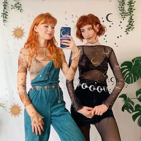 Mirror portrait of two celestial outfits, with the crescent moon chain belt worn over a black skirt at right.