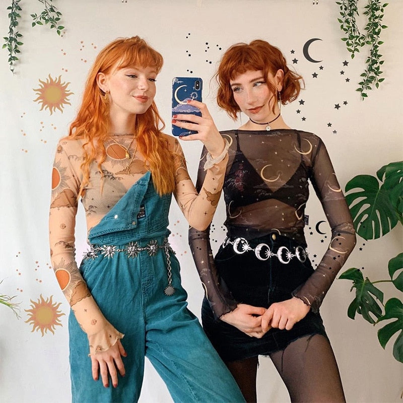 Mirror portrait of two celestial outfits, with the crescent moon chain belt worn over a black skirt at right.