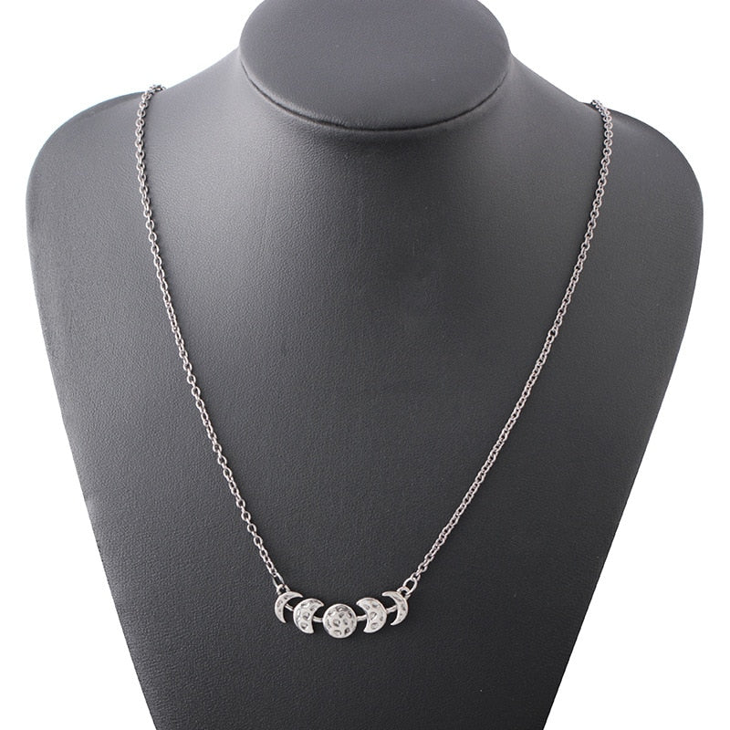 Silver-tone moon phase necklace shown with the full chain on a necklace display bust.