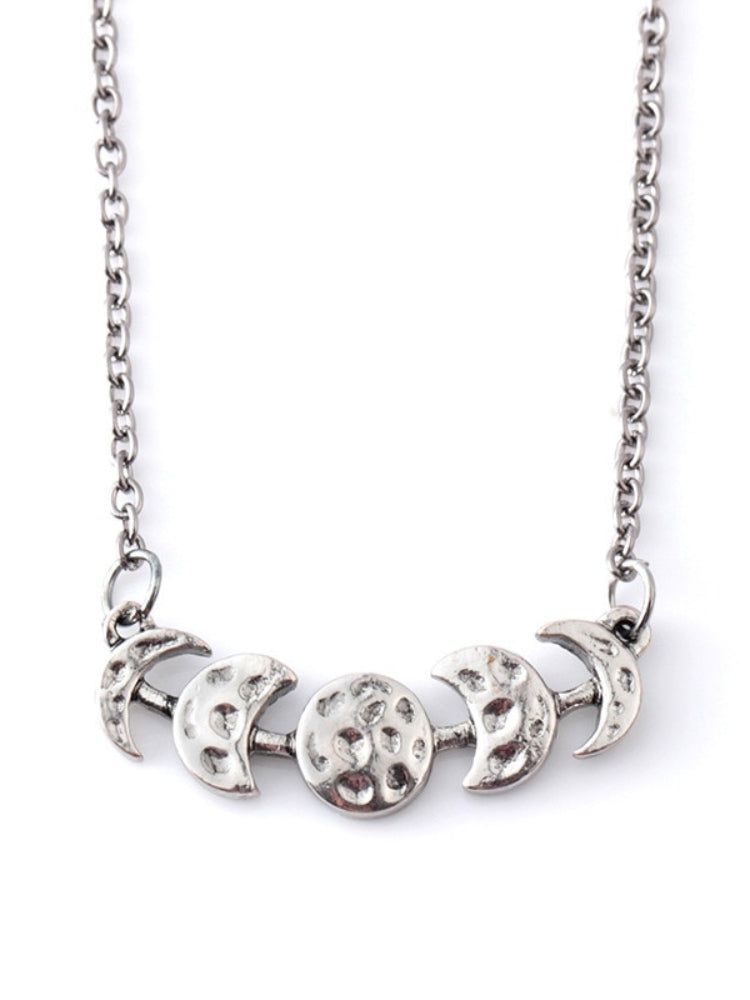 Silver-tone moon phase necklace shown from the front on white.