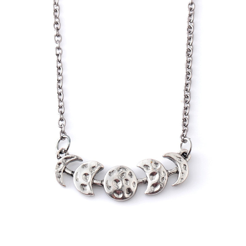 Silver-tone moon phase necklace with a closer view of the textured lunar centerpiece on white.