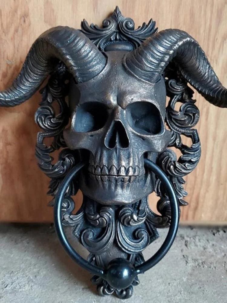 Horned skull door knocker on wooden door