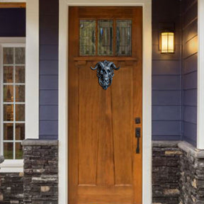 Skull ring knocker on warm wood door