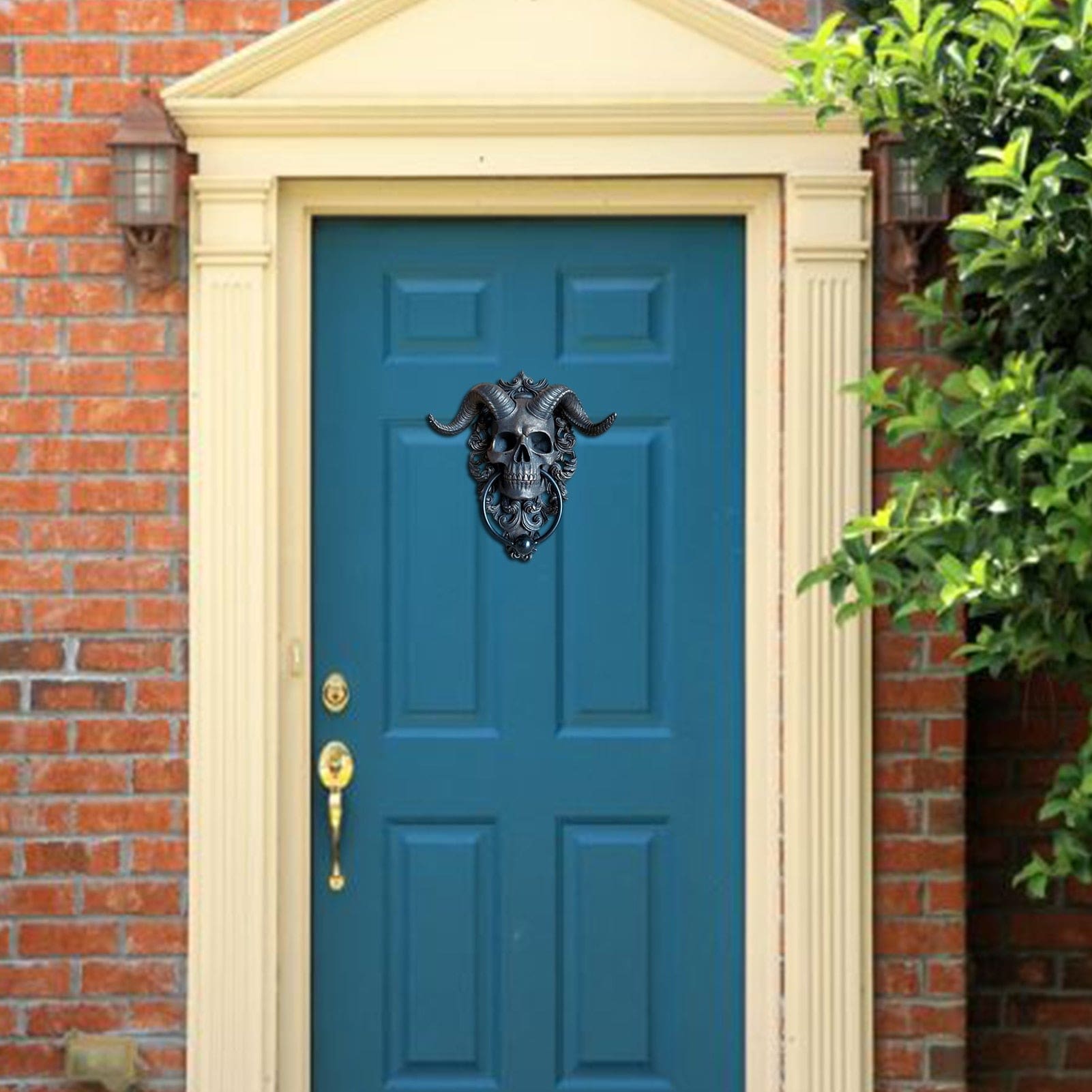 Horned skull knocker on blue door wider view