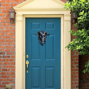 Skull ring knocker on blue door