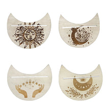 Four moon-shaped tarot card holders on white, showing individual sun, crystal, eye and hand designs.