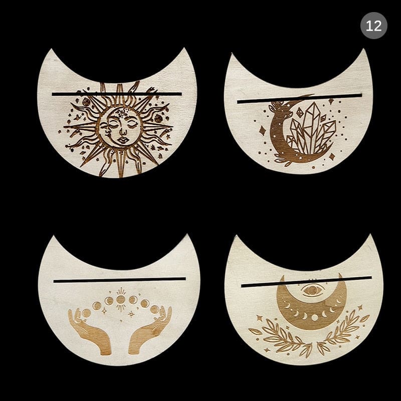 Four beige crescent card holders on a dark background, with sun, crystal, eye and hand motifs around the slots.