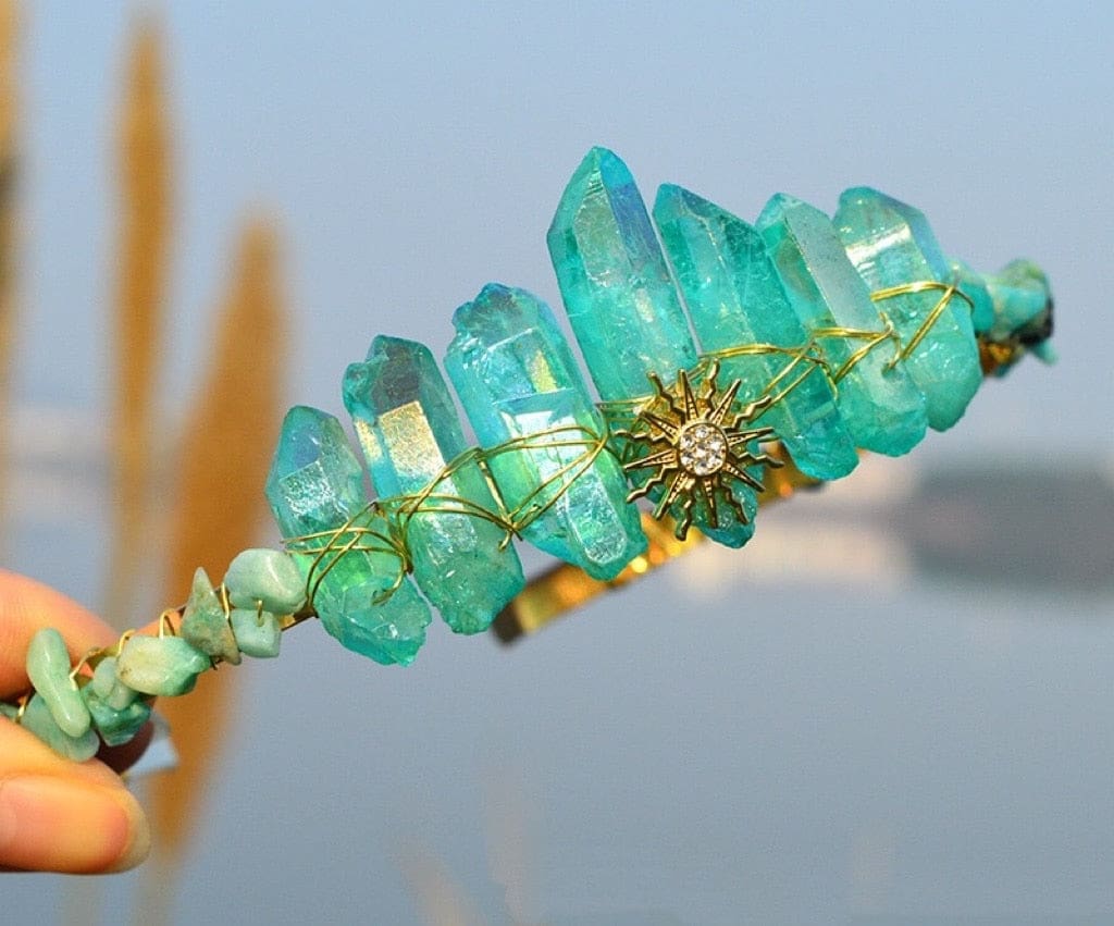 Teal crystal point tiara with a gold-tone sunburst, blue-green points and warm wrapped wire details.