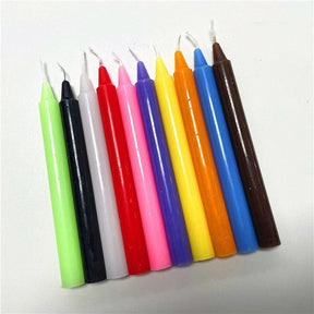 Ten loose candles arranged in a row, comparing dark, bright and pale colours across the slender ritual candles.