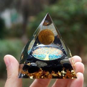 Tiger eye and obsidian orgone pyramid with a golden-brown sphere and blue Tree of Life inlay. Close upright view with the warm brown sphere and blue tree disc facing the camera.