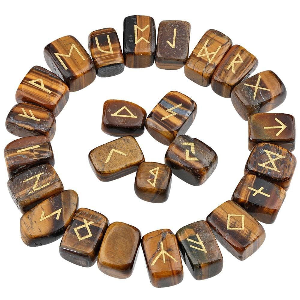 Tiger's eye rune stones arranged in a circle, with brown and golden-banded polished surfaces and gold-coloured characters. The set includes a blank stone.