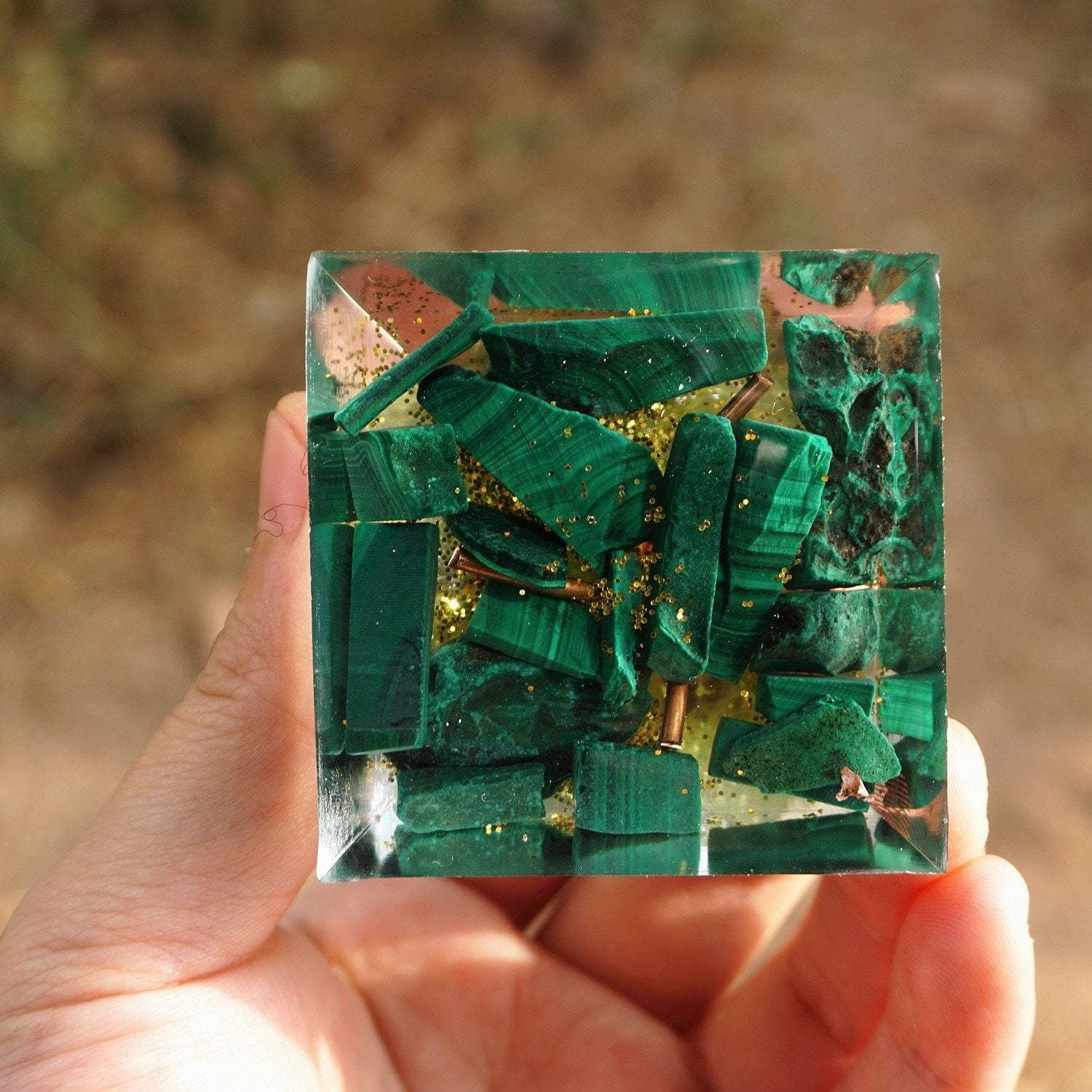Green malachite pieces and bright flecks fill the square underside of the Tree of Life pyramid.