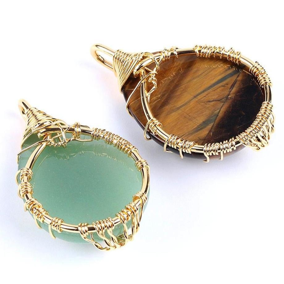 Back views of green and brown stone pendants, showing the gold-tone wire wrapping around their edges.