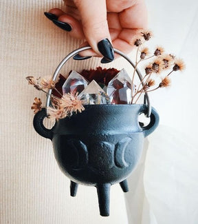 Cauldron styled with crystals and dried flowers